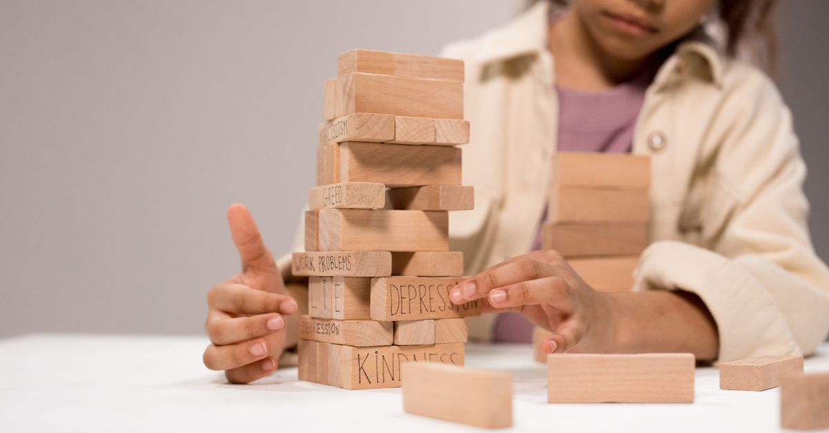 Supportive hands guiding wooden learning blocks